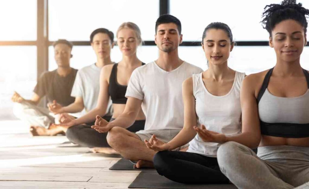 a group of students practising meditation