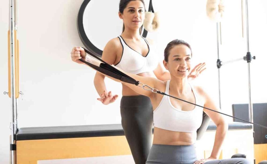 pilates instructor training her client