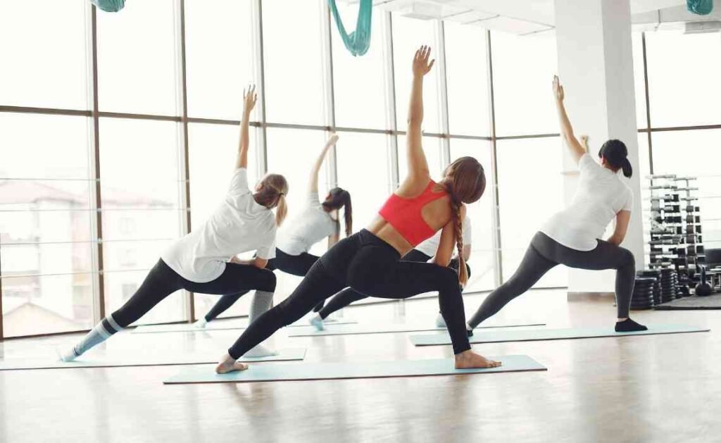 students performing pilates exercise
